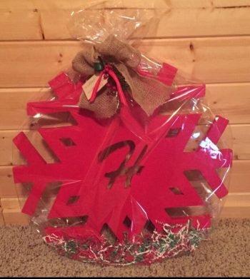 red DIY snowflake with monogram wrapped up as a gift
