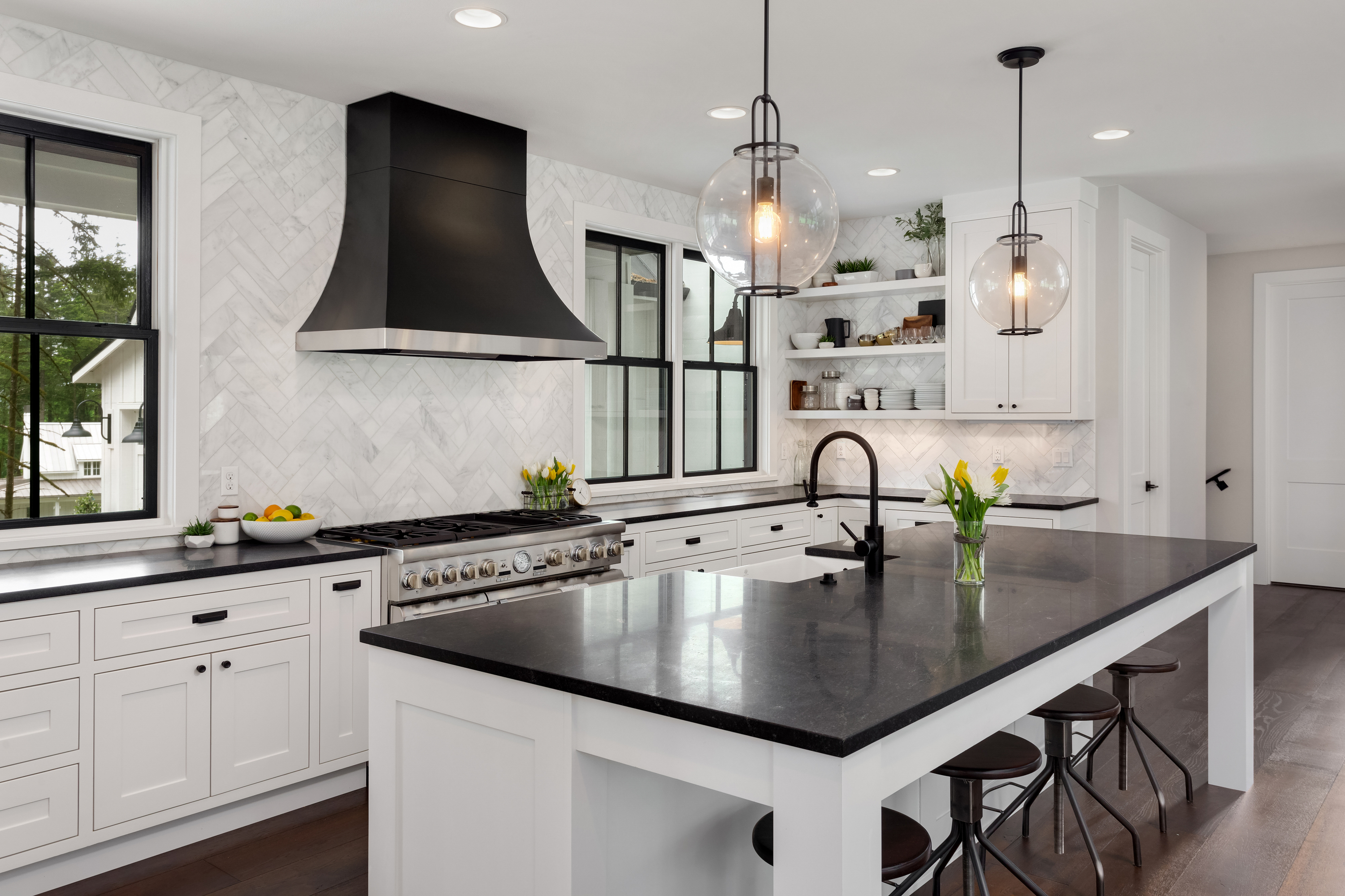 Isn't this kitchen gorgeous! The contrasting look of white cabinets black granite really just pops. If you're for more black and white kitchen ideas, look here. 